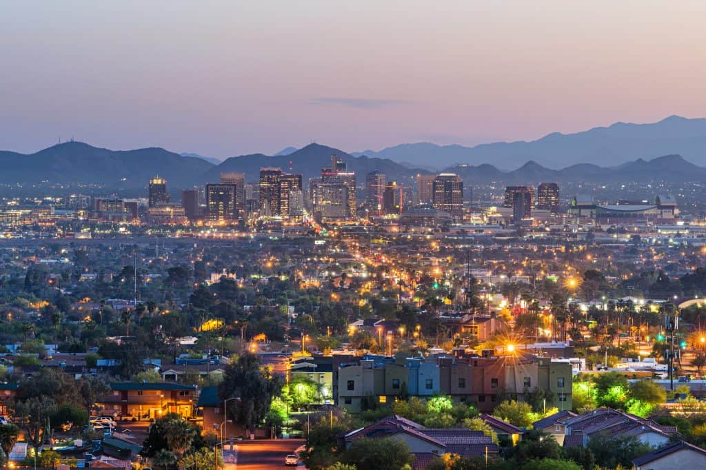 Luxury homes in Phoenix, Arizona, USA downtown cityscape at dusk.